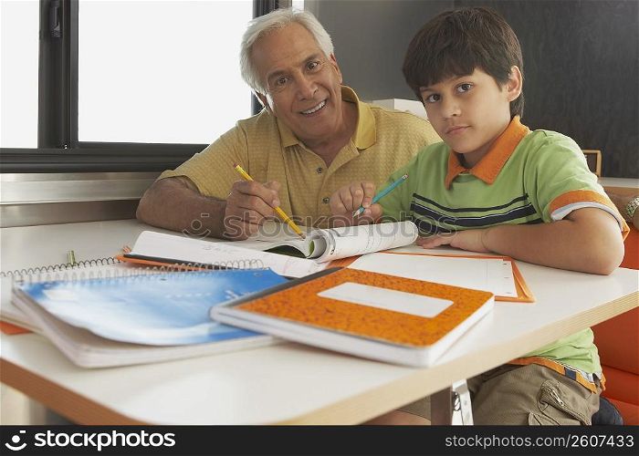 Portrait of a senior man teaching his grandson