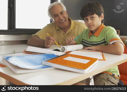 Portrait of a senior man teaching his grandson