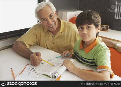 Portrait of a senior man teaching his grandson and smiling