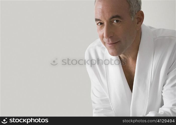 Portrait of a senior man wearing a bathrobe and smiling