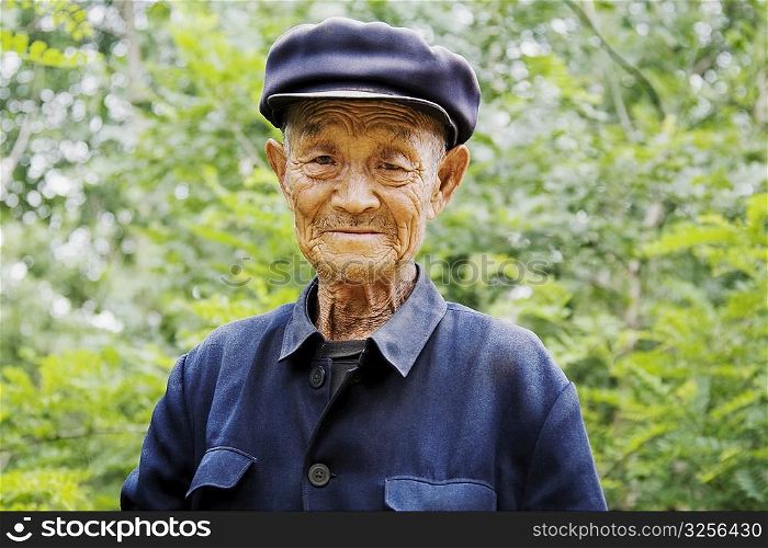 Portrait of a senior man wearing a flat cap, Zhigou, Shandong Province, China