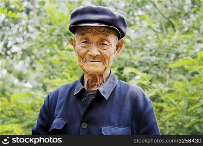 Portrait of a senior man wearing a flat cap, Zhigou, Shandong Province, China