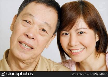 Portrait of a senior man with his daughter smiling