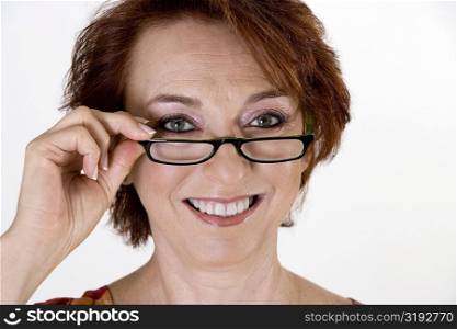 Portrait of a senior woman adjusting her eye glasses