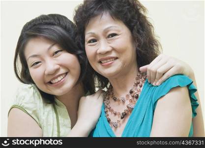 Portrait of a senior woman and her daughter smiling