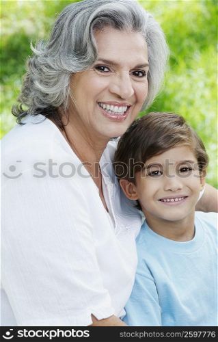 Portrait of a senior woman and her grandson smiling