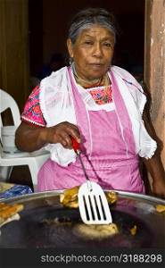 Portrait of a senior woman cooking, Cuetzalan, Puebla State, Mexico