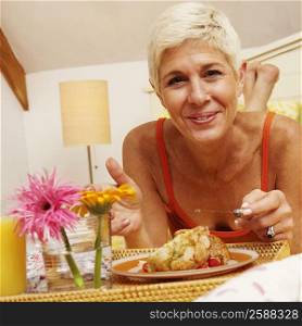 Portrait of a senior woman eating breakfast in bed