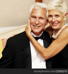 Portrait of a senior woman embracing a mature man and smiling