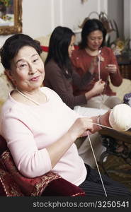 Portrait of a senior woman holding a ball of wool