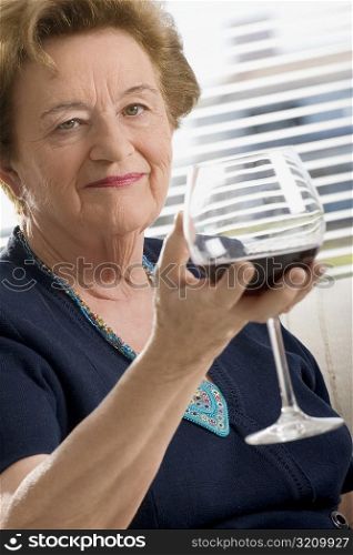Portrait of a senior woman holding a glass of wine