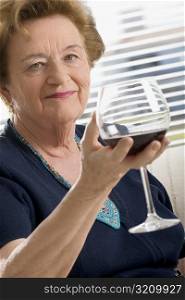 Portrait of a senior woman holding a glass of wine