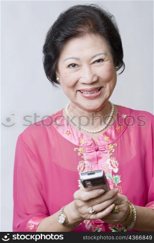 Portrait of a senior woman holding a mobile phone and smiling