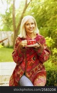 Portrait of a senior woman holding a tea cup and smiling