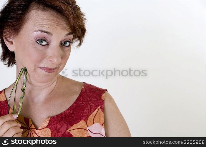 Portrait of a senior woman holding eyeglasses