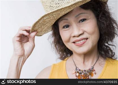 Portrait of a senior woman holding her hat