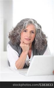 Portrait of a Senior woman in front of a laptop computer