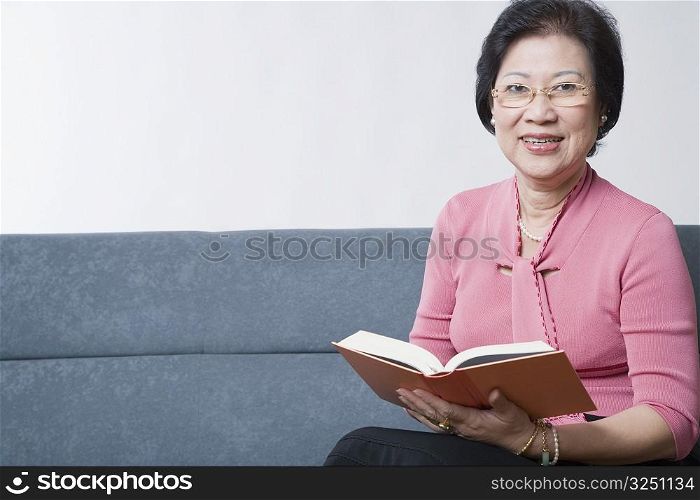 Portrait of a senior woman reading a book