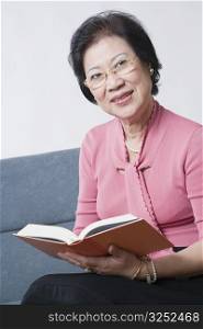 Portrait of a senior woman reading a book