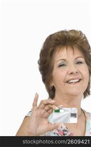 Portrait of a senior woman showing a credit card