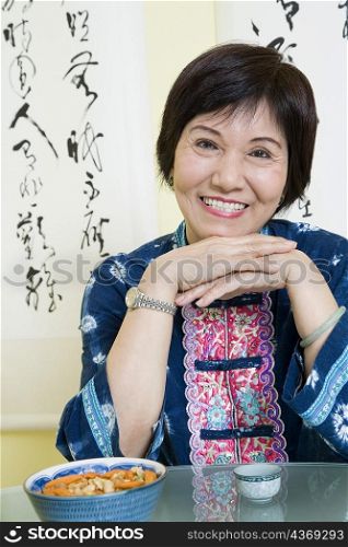 Portrait of a senior woman sitting at a table and smiling