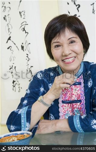 Portrait of a senior woman sitting at a table and smiling