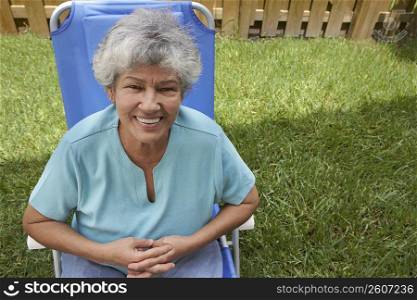 Portrait of a senior woman sitting in a lawn chair and smiling