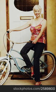 Portrait of a senior woman sitting on a bicycle