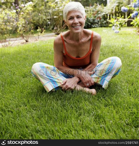 Portrait of a senior woman sitting on grass