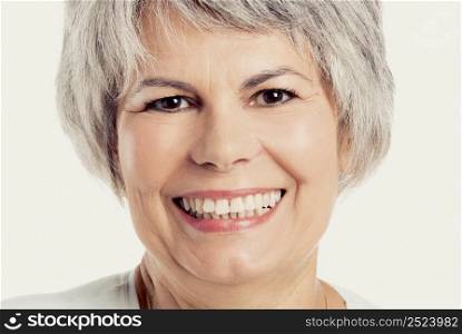 Portrait of a senior woman smiling, isolated on white