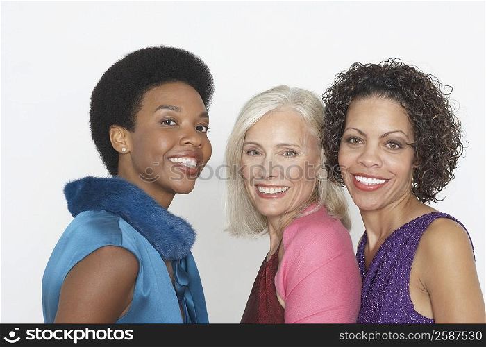 Portrait of a senior woman smiling with a mature woman and a young woman
