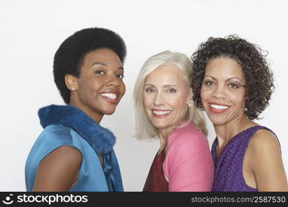 Portrait of a senior woman smiling with a mature woman and a young woman