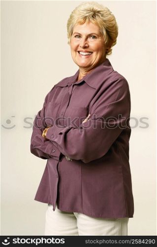 Portrait of a senior woman smiling with her arms crossed
