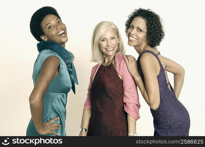 Portrait of a senior woman standing with a mature woman and a young woman and smiling