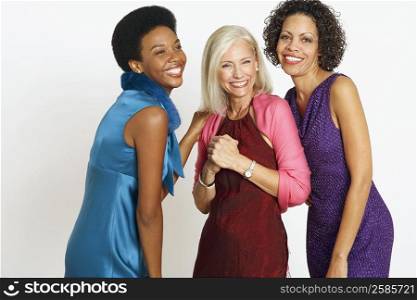 Portrait of a senior woman standing with a mature woman and young woman and smiling