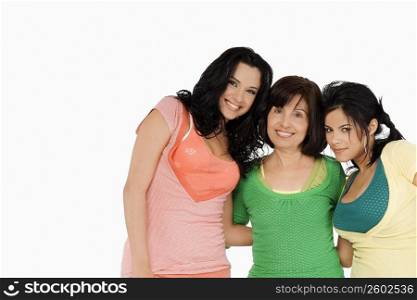 Portrait of a senior woman standing with her two daughters and smiling