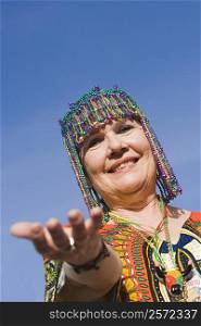 Portrait of a senior woman wearing a beaded headdress and smiling