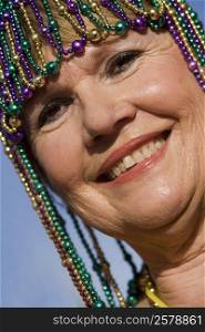 Portrait of a senior woman wearing a beaded headdress and smiling