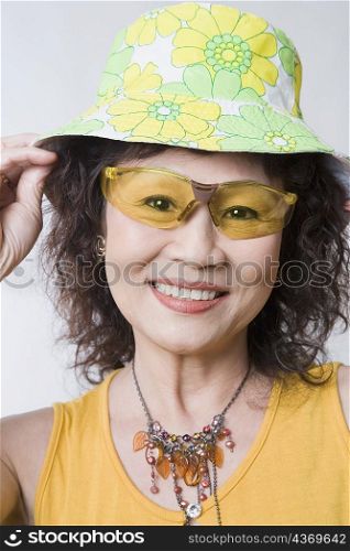 Portrait of a senior woman wearing sunglasses and a hat