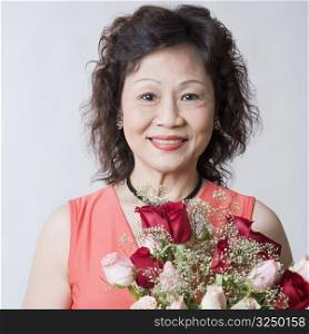 Portrait of a senior woman with a bouquet of flowers