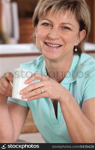 Portrait of a senior woman with a cup