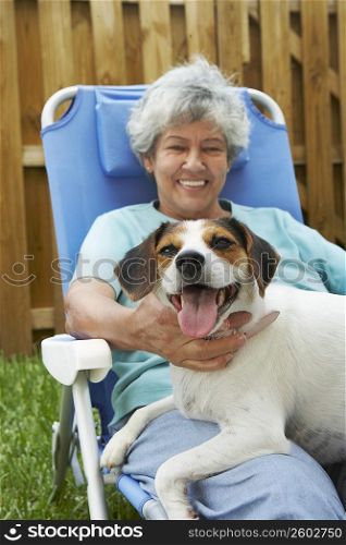 Portrait of a senior woman with a dog and smiling