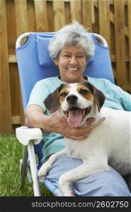 Portrait of a senior woman with a dog and smiling