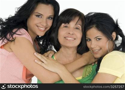 Portrait of a senior woman with her two daughters smiling