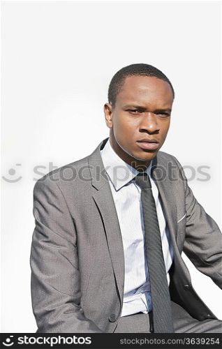Portrait of a serious African American businessman over white background