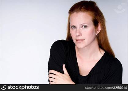 Portrait of a serious redheaded woman.