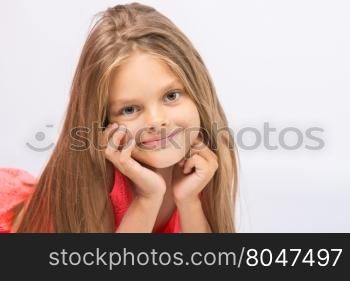 Portrait of a seven-year cheerful little girl on a white background