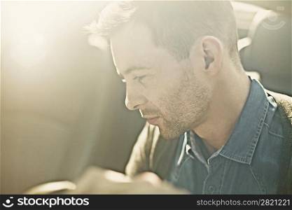 Portrait of a sexy fashion man in the car