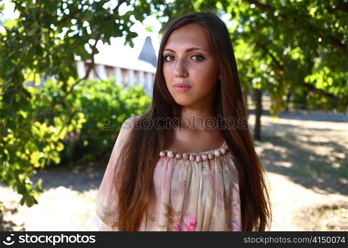 Portrait of a sexy young female in a park in sexy short dress