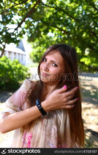 Portrait of a sexy young female in a park in sexy short dress